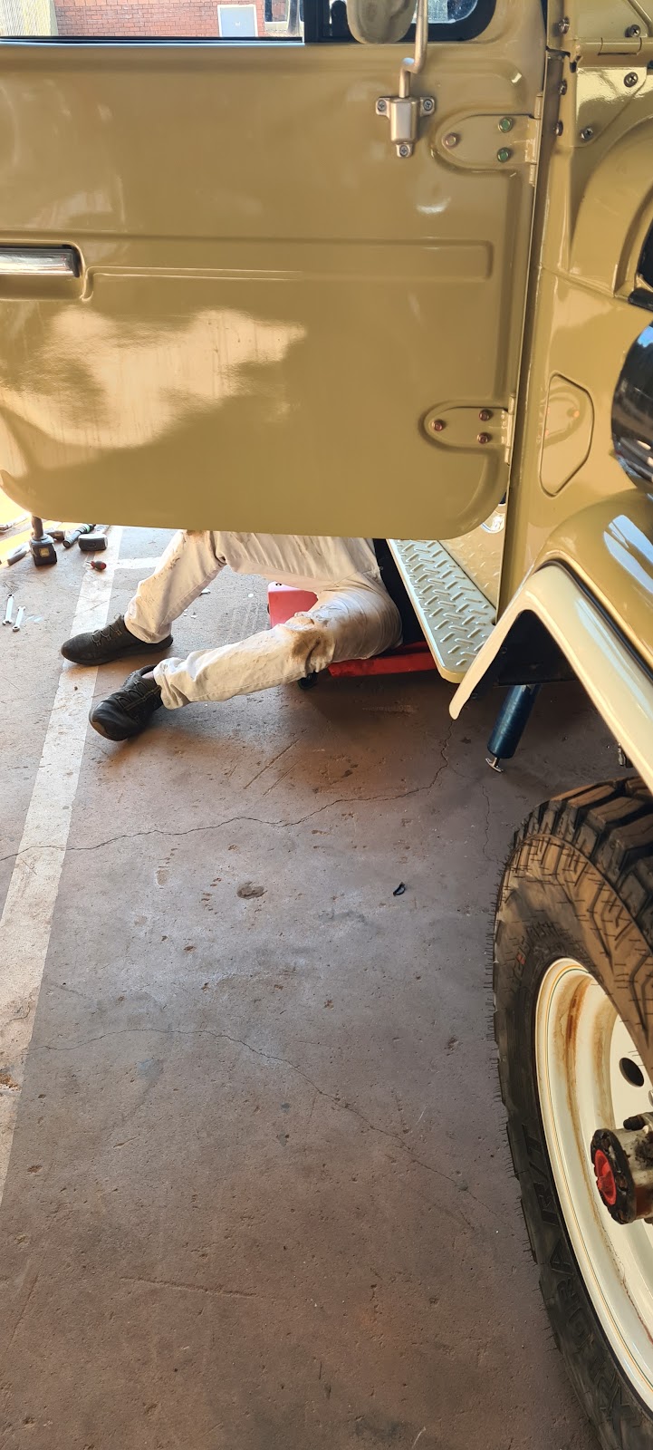 Working underneath a LandCruiser in the TJ Auto Tech workshop